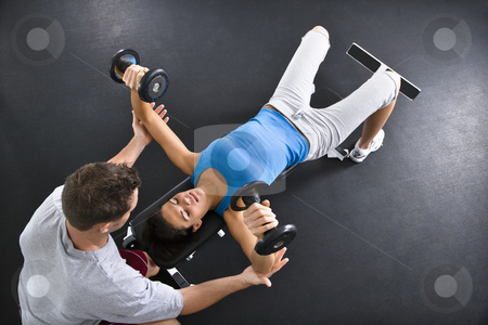 To use this stock image in your creative project, please select the size you need over to the right and click the "Add to Cart" button.
Your downloaded image will come with the Cutcaster watermark removed so don’t worry about the watermark you see on this page. Woman lifting weights stock photo, Man assisting woman lifting weights at gym. by Iofoto Images