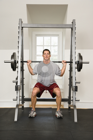 To use this stock image in your creative project, please select the size you need over to the right and click the "Add to Cart" button.
Your downloaded image will come with the Cutcaster watermark removed so don’t worry about the watermark you see on this page. Fitness training stock photo, Man lifting weights in gym. by Iofoto Images