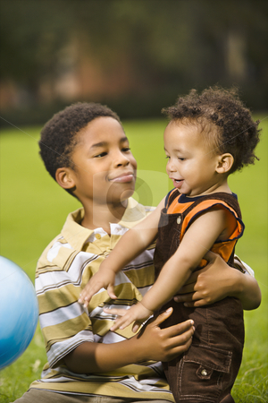 To use this stock image in your creative project, please select the size you need over to the right and click the "Add to Cart" button.
Your downloaded image will come with the Cutcaster watermark removed so don’t worry about the watermark you see on this page. Brothers playing stock photo, Big brother and little brother playing with ball in park. by Iofoto Images