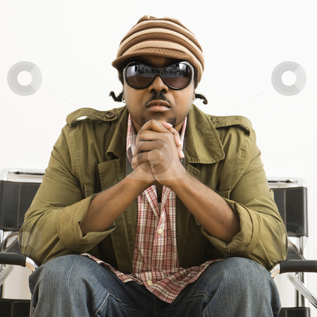 Serious stylish man. Serious stylish man. stock photo, African-American mid-adult man wearing hat and sunglasses and looking at viewer. by Iofoto Images