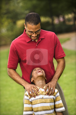 To use this stock image in your creative project, please select the size you need over to the right and click the "Add to Cart" button.
Your downloaded image will come with the Cutcaster watermark removed so don’t worry about the watermark you see on this page. Dad and son stock photo, Father standing behind son with hands on his shoulders as boy smiles. by Iofoto Images