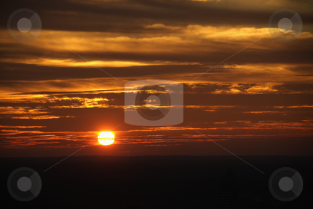 To use this stock image in your creative project, please select the size you need over to the right and click the "Add to Cart" button.
Your downloaded image will come with the Cutcaster watermark removed so don’t worry about the watermark you see on this page. Sunset. stock photo, Sun setting in orange sky with clouds. by Iofoto Images