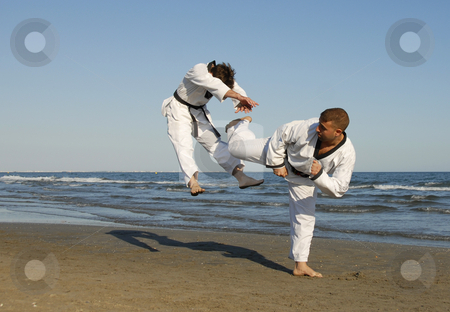 To use this stock image in your creative project, please select the size you need over to the right and click the "Add to Cart" button.
Your downloaded image will come with the Cutcaster watermark removed so don’t worry about the watermark you see on this page. Taekwondo, kickboxing stock photo, Training of the two young men on the beach: taekwondo by Bonzami Emmanuelle
