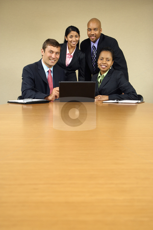 Office gathering. Office gathering. stock photo, Businesspeople gathered around laptop computer smiling. by Iofoto Images