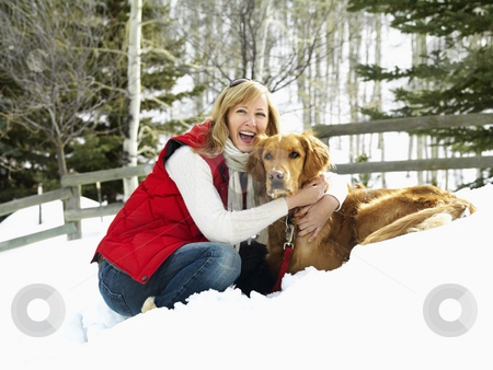 To use this stock image in your creative project, please select the size you need over to the right and click the "Add to Cart" button.
Your downloaded image will come with the Cutcaster watermark removed so don’t worry about the watermark you see on this page. Winter portrait. stock photo, Woman hugging dog while bending down in the snow. by Iofoto Images
