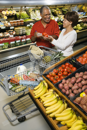 To use this stock image in your creative project, please select the size you need over to the right and click the "Add to Cart" button.
Your downloaded image will come with the Cutcaster watermark removed so don’t worry about the watermark you see on this page. Couple grocery shopping. stock photo, Smiling middle aged African American couple comparing produce in grocery store. by Iofoto Images