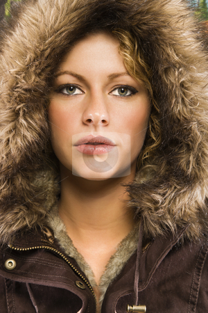 Woman in winter coat.. Woman in winter coat.. stock photo, Caucasian young adult woman wearing fur hood looking at viewer. by Iofoto Images