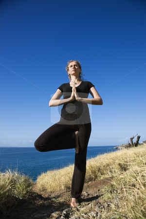 To use this stock image in your creative project, please select the size you need over to the right and click the "Add to Cart" button.
Your downloaded image will come with the Cutcaster watermark removed so don’t worry about the watermark you see on this page. Woman practicing yoga. stock photo, Caucasian mid-adult woman standing on Hawaiian coast in Yoga tree position. by Iofoto Images