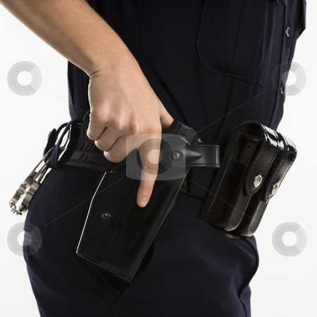 To use this stock image in your creative project, please select the size you need over to the right and click the "Add to Cart" button.
Your downloaded image will come with the Cutcaster watermark removed so don’t worry about the watermark you see on this page. Armed policewoman. stock photo, Close up side view of mid adult female Caucasian law enforcement officer hand on gun in holster. by Iofoto Images