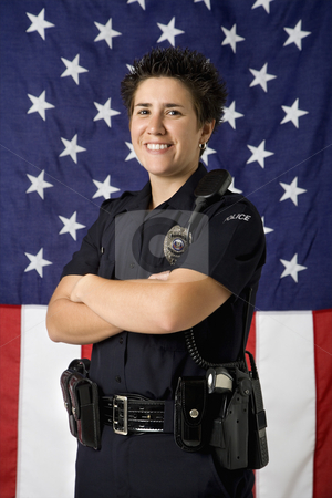To use this stock image in your creative project, please select the size you need over to the right and click the "Add to Cart" button.
Your downloaded image will come with the Cutcaster watermark removed so don’t worry about the watermark you see on this page. Policewoman and flag. stock photo, Portrait of mid adult Caucasian policewoman standing with arms crossed with American flag as backdrop smiling at viewer. by Iofoto Images