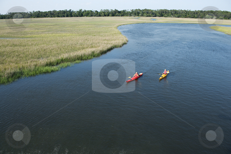 To use this stock image in your creative project, please select the size you need over to the right and click the "Add to Cart" button.
Your downloaded image will come with the Cutcaster watermark removed so don’t worry about the watermark you see on this page. Two boys kayaking. stock photo, Aerial of two teenage boys kayaking through marshland on Bald Head Island, North Carolina. by Iofoto Images