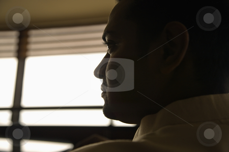 Profile of man. Profile of man. stock photo, Profile view of young adult male Indian slihouetted near window. by Iofoto Images