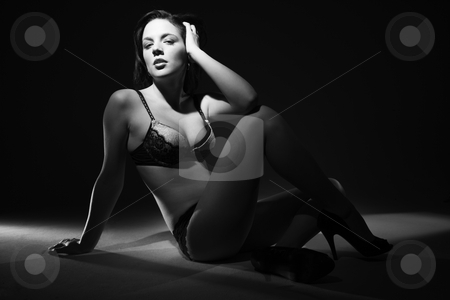 Sexy woman in lingerie. Sexy woman in lingerie. stock photo, Sexy Caucasian woman in lingerie with hand to head sitting on floor. by Iofoto Images