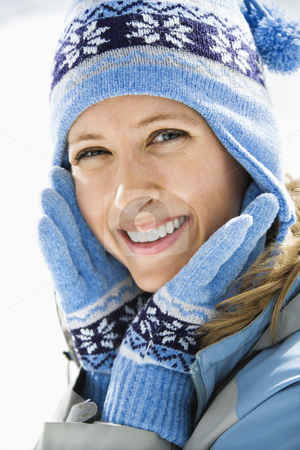 Attractive smiling woman. Attractive smiling woman. stock photo, Portrait of attractive smiling mid adult Caucasian woman wearing blue ski cap and gloves looking at viewer. by Iofoto Images