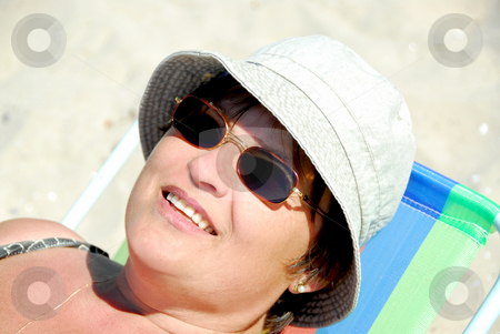 Woman beach Woman beach stock photo, Mature woman relaxing in a beach chair by Elena Elisseeva