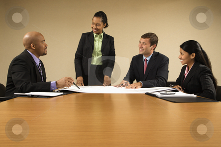 People working. People working. stock photo, Businesspeople having meeting at conference table. by Iofoto Images