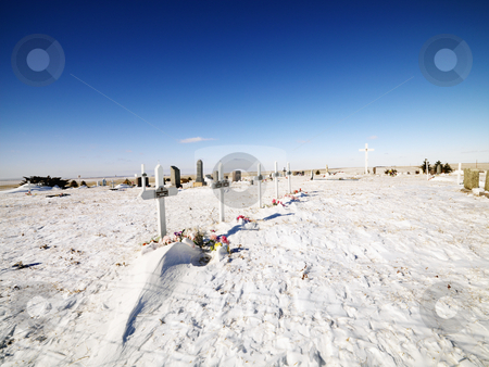 To use this stock image in your creative project, please select the size you need over to the right and click the "Add to Cart" button.
Your downloaded image will come with the Cutcaster watermark removed so don’t worry about the watermark you see on this page. Snow covered graveyard. stock photo, Snow covered graveyard with clear blue sky in background. by Iofoto Images