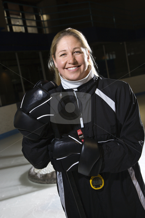 Female hockey coach. Female hockey coach. stock photo, Female hockey coach in uniform standing smiling. by Iofoto Images