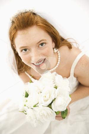To use this stock image in your creative project, please select the size you need over to the right and click the "Add to Cart" button.
Your downloaded image will come with the Cutcaster watermark removed so don’t worry about the watermark you see on this page. Bride holding bouquet. stock photo, Portrait of a Caucasian bride holding bouquet looking up towards viewer. by Iofoto Images