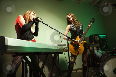 To use this stock image in your creative project, please select the size you need over to the right and click the "Add to Cart" button.
Your downloaded image will come with the Cutcaster watermark removed so don’t worry about the watermark you see on this page. Girl band. stock photo, Caucasian girl band playing instruments. by Iofoto Images