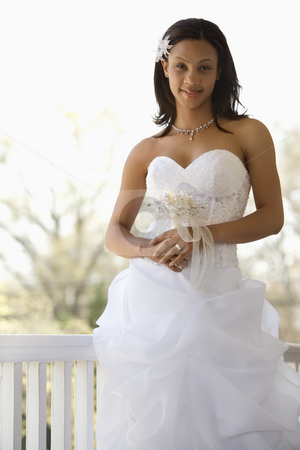 Bridal portrait. Bridal portrait. stock photo, Portrait of African-American bride leaning against railing. by Iofoto Images