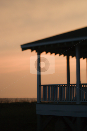 Beachfront porch silhouetted at sunset Beachfront porch silhouetted at sunset stock photo, Beachfront porch silhouetted at sunset by Iofoto Images