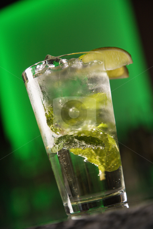 To use this stock image in your creative project, please select the size you need over to the right and click the "Add to Cart" button.
Your downloaded image will come with the Cutcaster watermark removed so don’t worry about the watermark you see on this page. Mixed drink cocktail. stock photo, Still life of mixed drink cocktail with mint leaves and fruit garnish against glowing green background. by Iofoto Images