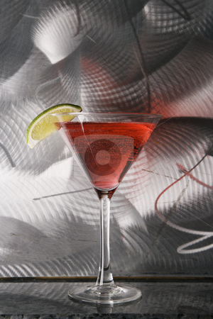 Still life of martini. Still life of martini. stock photo, Still life of martini mixed drink with raspberry fruit agaisnt textured metallic background. by Iofoto Images