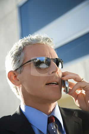 To use this stock image in your creative project, please select the size you need over to the right and click the "Add to Cart" button.
Your downloaded image will come with the Cutcaster watermark removed so don’t worry about the watermark you see on this page. Businessman talking on cellphone. stock photo, Close up side view of prime adult Caucasian man in suit talking on cellphone in urban setting. by Iofoto Images