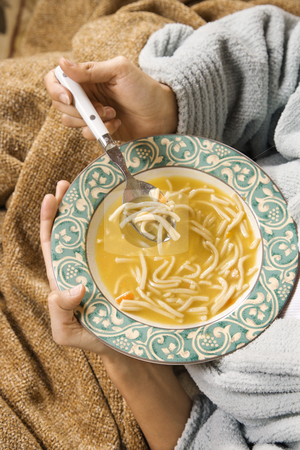 Chicken noodle soup. Chicken noodle soup. stock photo, Bowl of chicken noodle soup held in Caucasian/Hispanic hands. by Iofoto Images
