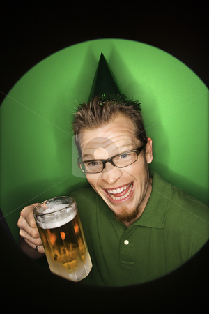 To use this stock image in your creative project, please select the size you need over to the right and click the "Add to Cart" button.
Your downloaded image will come with the Cutcaster watermark removed so don’t worry about the watermark you see on this page. Man holding beer. stock photo, Vignette of adult Caucasian man on green background wearing green hat and holding beer. by Iofoto Images