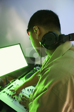 To use this stock image in your creative project, please select the size you need over to the right and click the "Add to Cart" button.
Your downloaded image will come with the Cutcaster watermark removed so don’t worry about the watermark you see on this page. Man with audio equipment. stock photo, Rear view of Asian young adult male DJ mixing music on equipment. by Iofoto Images