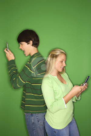 To use this stock image in your creative project, please select the size you need over to the right and click the "Add to Cart" button.
Your downloaded image will come with the Cutcaster watermark removed so don’t worry about the watermark you see on this page. Boy and girl on cellphones. stock photo, Portrait of Caucasian teen boy and girl on cellphones standing with backs to eachother against green background. by Iofoto Images