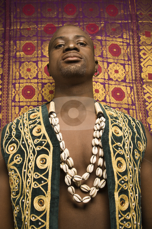 To use this stock image in your creative project, please select the size you need over to the right and click the "Add to Cart" button.
Your downloaded image will come with the Cutcaster watermark removed so don’t worry about the watermark you see on this page. Man in African garments. stock photo, Low angle portrait of African-American mid-adult man wearing embroidered African vest and beads. by Iofoto Images