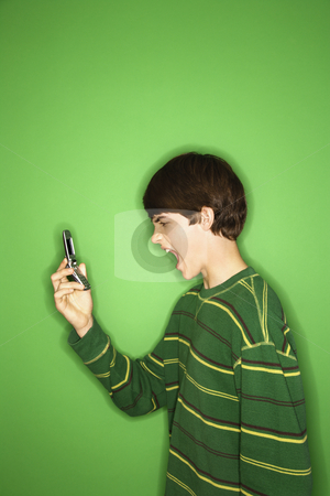 To use this stock image in your creative project, please select the size you need over to the right and click the "Add to Cart" button.
Your downloaded image will come with the Cutcaster watermark removed so don’t worry about the watermark you see on this page. Boy yelling into phone. stock photo, Portrait of Caucasian teen boy screaming at cellphone. by Iofoto Images