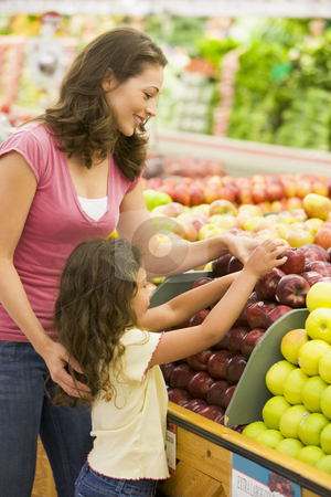 Mother and daughter in produce section Mother and daughter in produce section stock photo, Mother and daughter in produce section of supermarket by Monkey Business Images