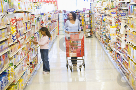 Mother and daughter shopping in supermarket Mother and daughter shopping in supermarket stock photo, Mother and daughter shopping for groceries in supermarket by Monkey Business Images