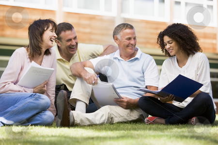 Adult students sitting on a campus lawn Adult students sitting on a campus lawn stock photo, by Monkey Business Images