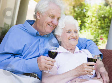 Senior couple relaxing with glass of wine Senior couple relaxing with glass of wine stock photo, Senior couple relaxing with glass of red wine by Monkey Business Images