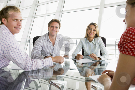 To use this stock image in your creative project, please select the size you need over to the right and click the "Add to Cart" button.
Your downloaded image will come with the Cutcaster watermark removed so don’t worry about the watermark you see on this page. Four businesspeople in a boardroom with paperwork smiling stock photo, by Monkey Business Images