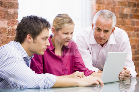 To use this stock image in your creative project, please select the size you need over to the right and click the "Add to Cart" button.
Your downloaded image will come with the Cutcaster watermark removed so don’t worry about the watermark you see on this page. Three businesspeople in office looking at laptop stock photo, by Monkey Business Images