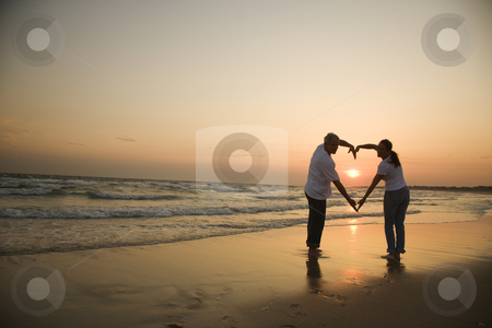 To use this stock image in your creative project, please select the size you need over to the right and click the "Add to Cart" button.
Your downloaded image will come with the Cutcaster watermark removed so don’t worry about the watermark you see on this page. Couple in love. stock photo, Mid-adult couple making heart shape with arms on beach at sunset. by Iofoto Images