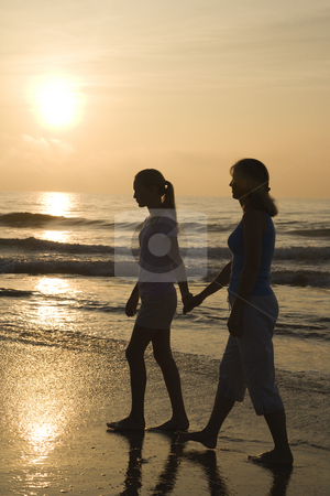 To use this stock image in your creative project, please select the size you need over to the right and click the "Add to Cart" button.
Your downloaded image will come with the Cutcaster watermark removed so don’t worry about the watermark you see on this page. Mom and daughter at sunrise. stock photo, Caucasian prime adult female and female child walking on beach at sunset holding hands. by Iofoto Images