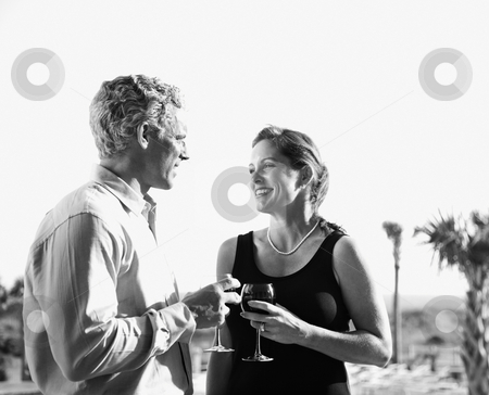 To use this stock image in your creative project, please select the size you need over to the right and click the "Add to Cart" button.
Your downloaded image will come with the Cutcaster watermark removed so don’t worry about the watermark you see on this page. Caucasian couple holding wine glasses. stock photo, Black and white image of mid-adult Caucasian couple holding wine glasses and smiling at each other. by Iofoto Images