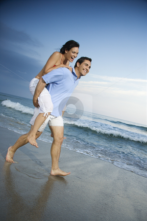 To use this stock image in your creative project, please select the size you need over to the right and click the "Add to Cart" button.
Your downloaded image will come with the Cutcaster watermark removed so don’t worry about the watermark you see on this page. Couple on beach. stock photo, Caucasian mid-adult male carrying female piggyback style on beach. by Iofoto Images