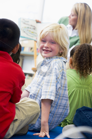 To use this stock image in your creative project, please select the size you need over to the right and click the "Add to Cart" button.
Your downloaded image will come with the Cutcaster watermark removed so don’t worry about the watermark you see on this page. Kindergarten teacher reading to children in library, boy looking stock photo, by Monkey Business Images