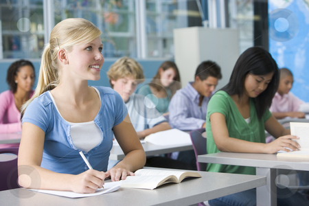 Schoolgirl in high school class Schoolgirl in high school class stock photo, by Monkey Business Images