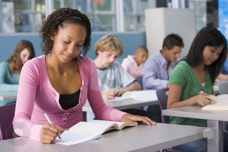Schoolgirl in high school class Schoolgirl in high school class stock photo, by Monkey Business Images