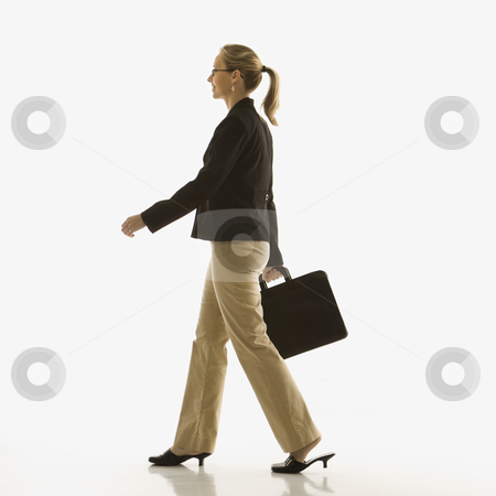 Businesswoman with briefcase. Businesswoman with briefcase. stock photo, Mid-adult Caucasian businesswoman walking and carrying briefcase. by Iofoto Images