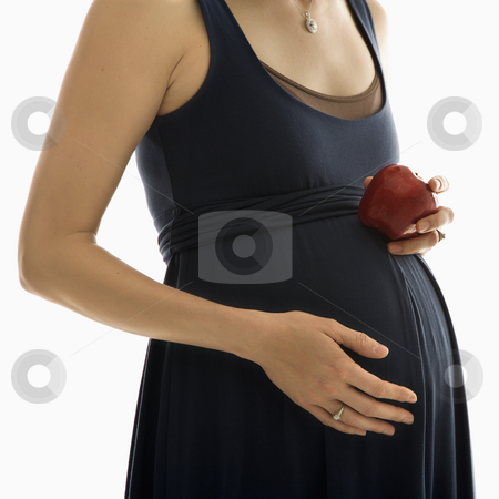 To use this stock image in your creative project, please select the size you need over to the right and click the "Add to Cart" button.
Your downloaded image will come with the Cutcaster watermark removed so don’t worry about the watermark you see on this page. Pregnant woman with apple. stock photo, Portrait of Caucasion mid-adult pregnant woman with hands on belly holding an apple. by Iofoto Images